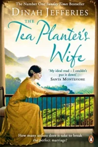 A book cover for "The Tea Planter's Wife" by Dinah Jefferies. The cover features a portrait of a woman with a determined expression, wearing a traditional hat and dress. The book is described as a Sunday Times bestseller and is praised by Santa Montefiore.