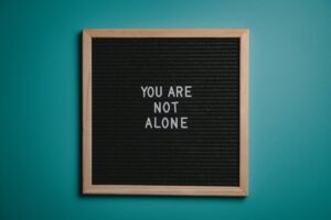 A letter board with the message "You are not alone.